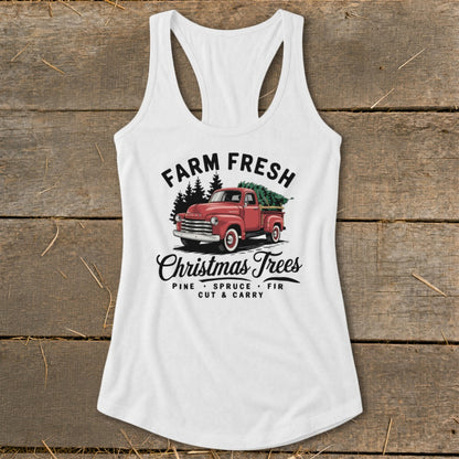 White tank top with "Farm Fresh Christmas Trees" graphic featuring a red truck with trees.