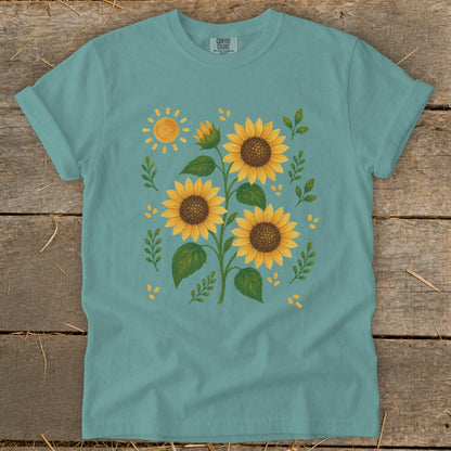 Teal t-shirt with a watercolor-style sunflower print and a bright sun.