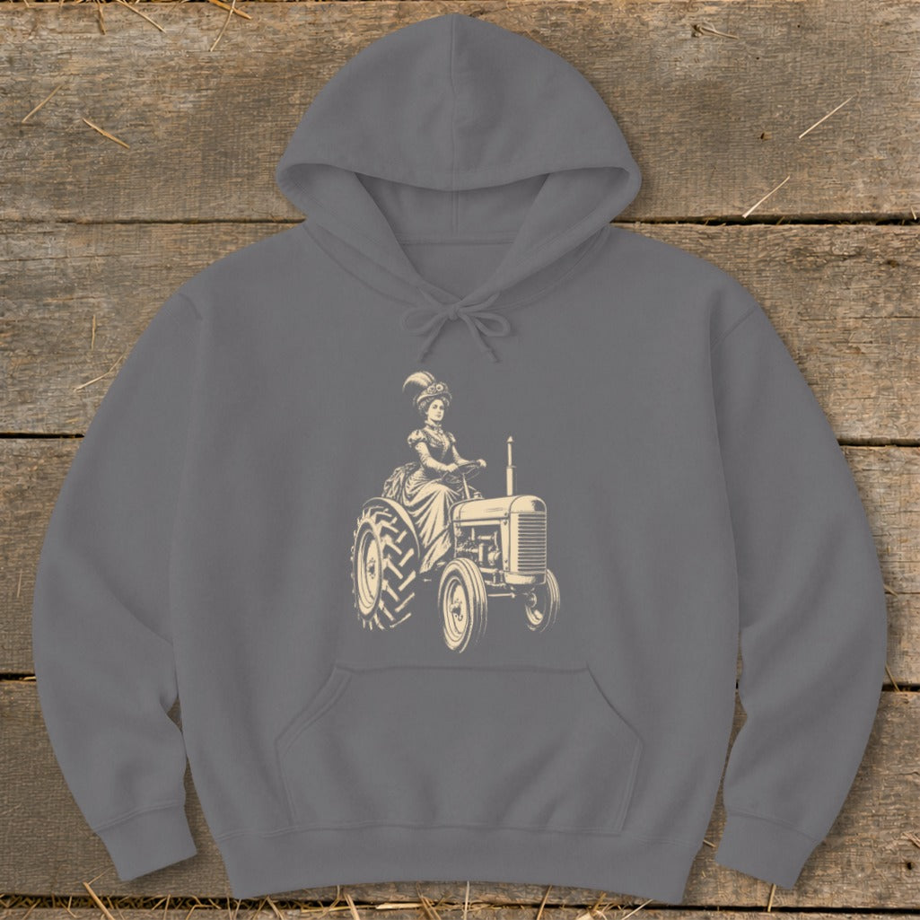 Line art of a woman in vintage dress driving an old tractor on a gray hoodie.