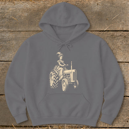 Line art of a woman in vintage dress driving an old tractor on a gray hoodie.