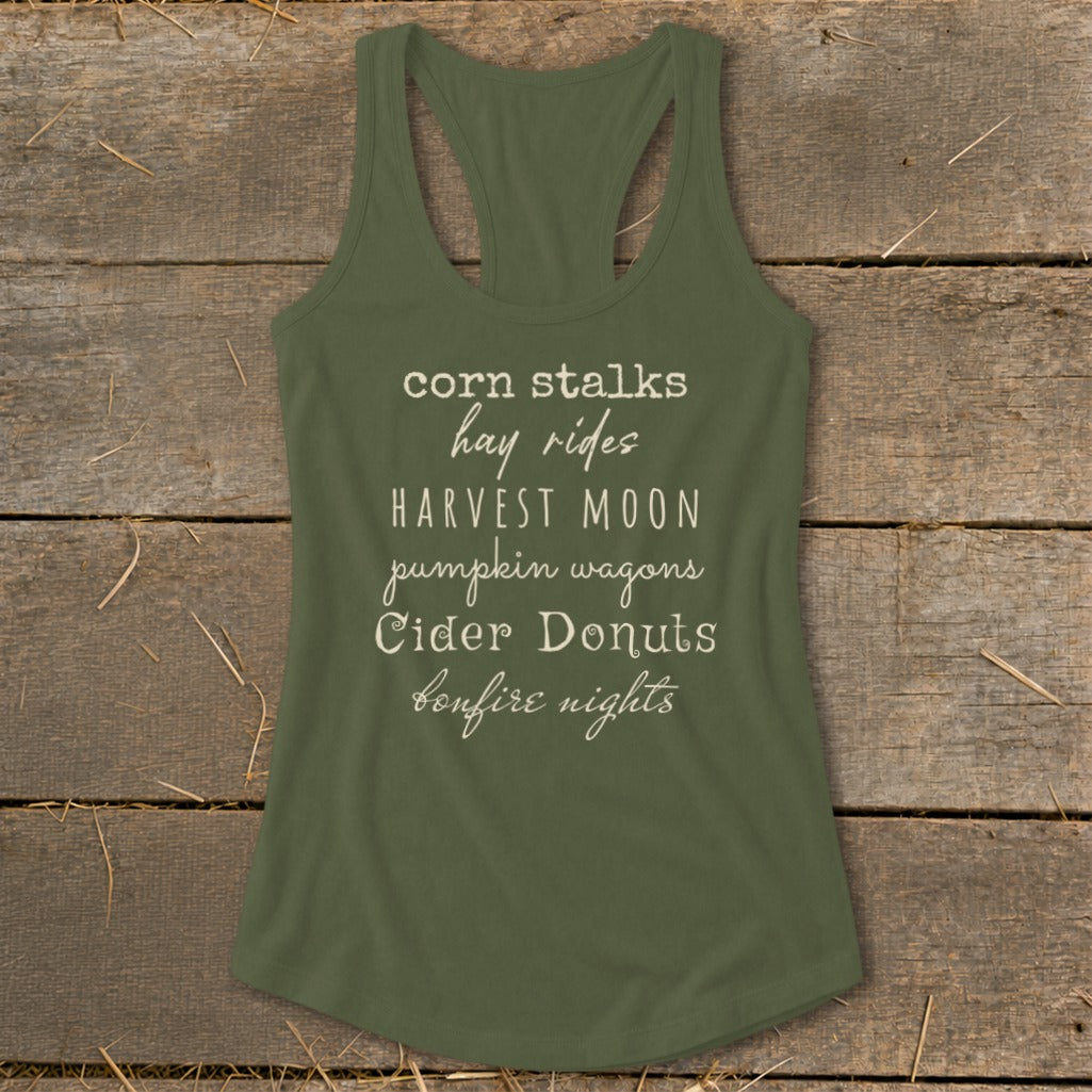 Olive green tank top with text "corn stalks hay rides HARVEST MOON pumpkin wagons Cider Donuts bonfire nights".