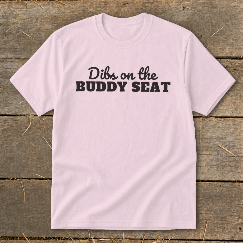 Pink t-shirt with "Dibs on the BUDDY SEAT" text in black.