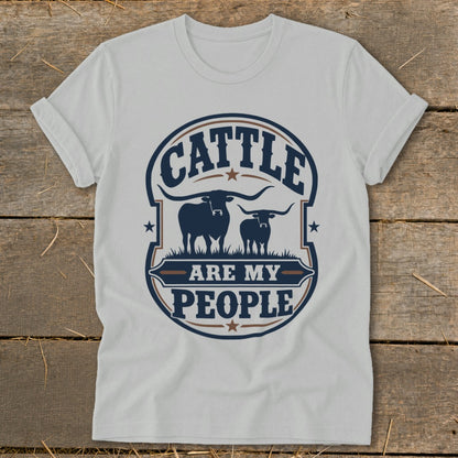 White t-shirt with "Cattle Are My People" text and two longhorn cows graphic.