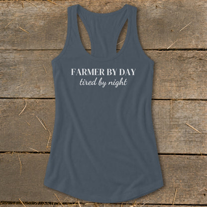 Gray racerback tank top with white text that says "FARMER BY DAY tired by night".