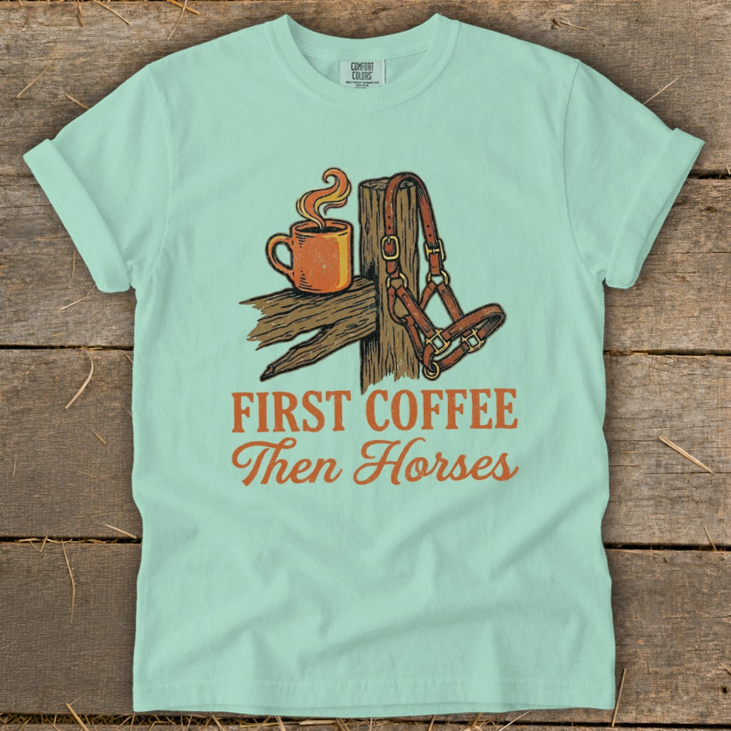 Teal t-shirt with "First Coffee Then Horses" graphic featuring a coffee mug and horse halter.