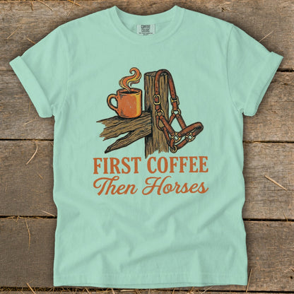 Teal t-shirt with "First Coffee Then Horses" graphic featuring a coffee mug and horse halter.