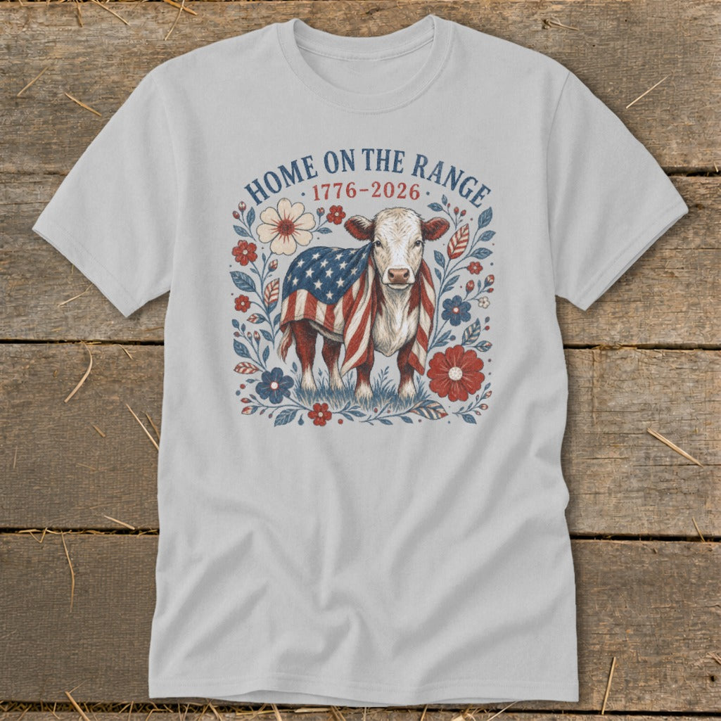 Light grey t-shirt with a cow draped in an American flag and floral design, text "HOME ON THE RANGE".