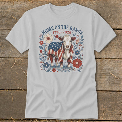 Light grey t-shirt with a cow draped in an American flag and floral design, text "HOME ON THE RANGE".