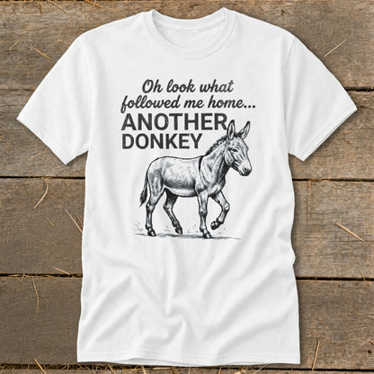 White t-shirt with text "Oh look what followed me home... ANOTHER DONKEY" and a donkey illustration.