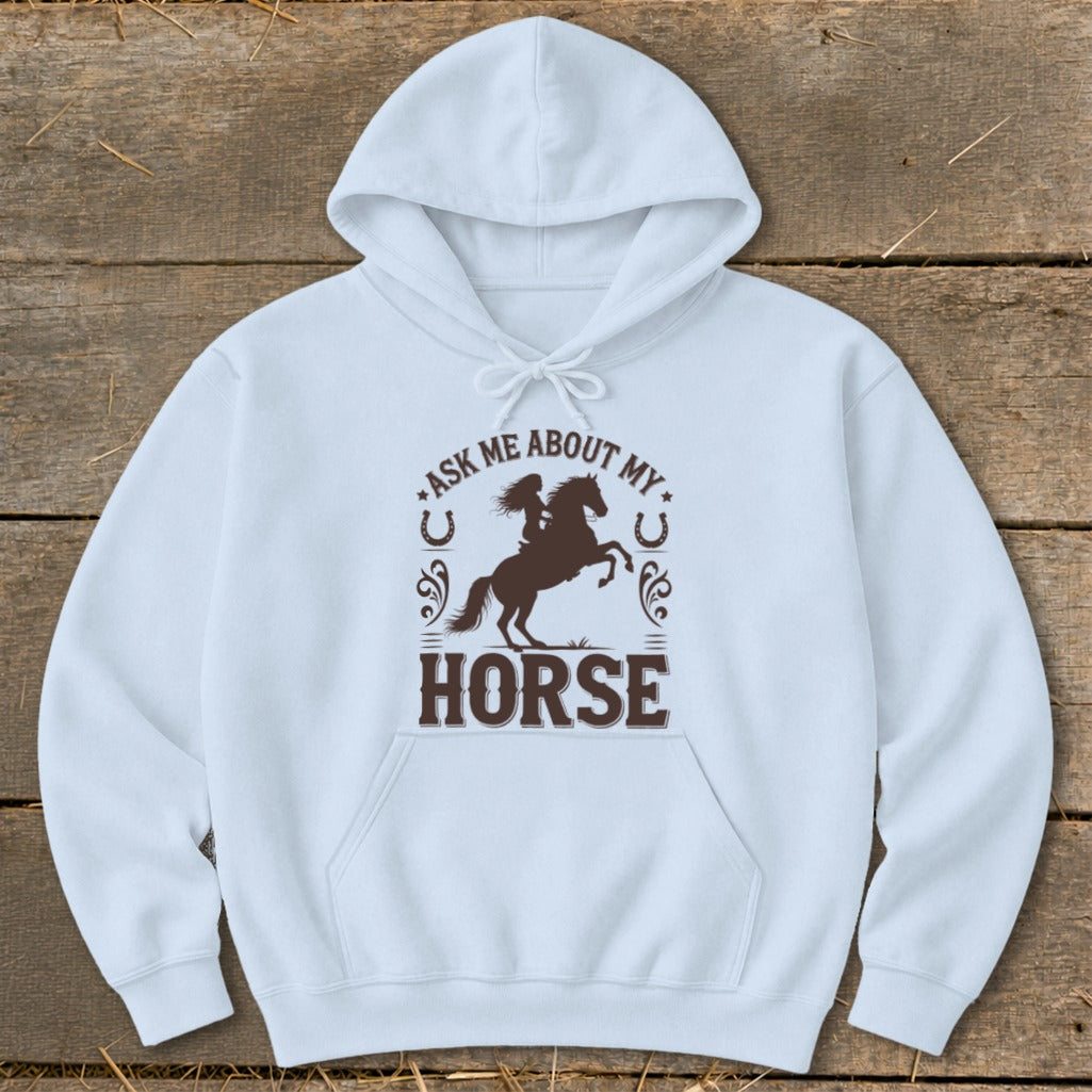Light blue hoodie with brown graphic featuring a rider on a horse and text "ASK ME ABOUT MY HORSE".
