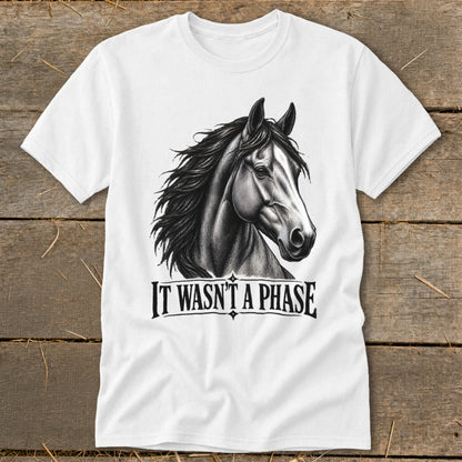 White t-shirt with a black and white drawing of a horse and text "IT WASN'T A PHASE."