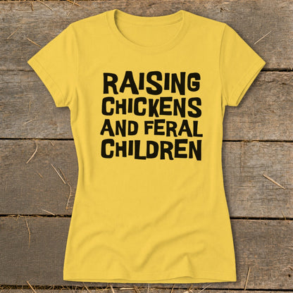 Yellow t-shirt with black text "RAISING CHICKENS AND FERAL CHILDREN"