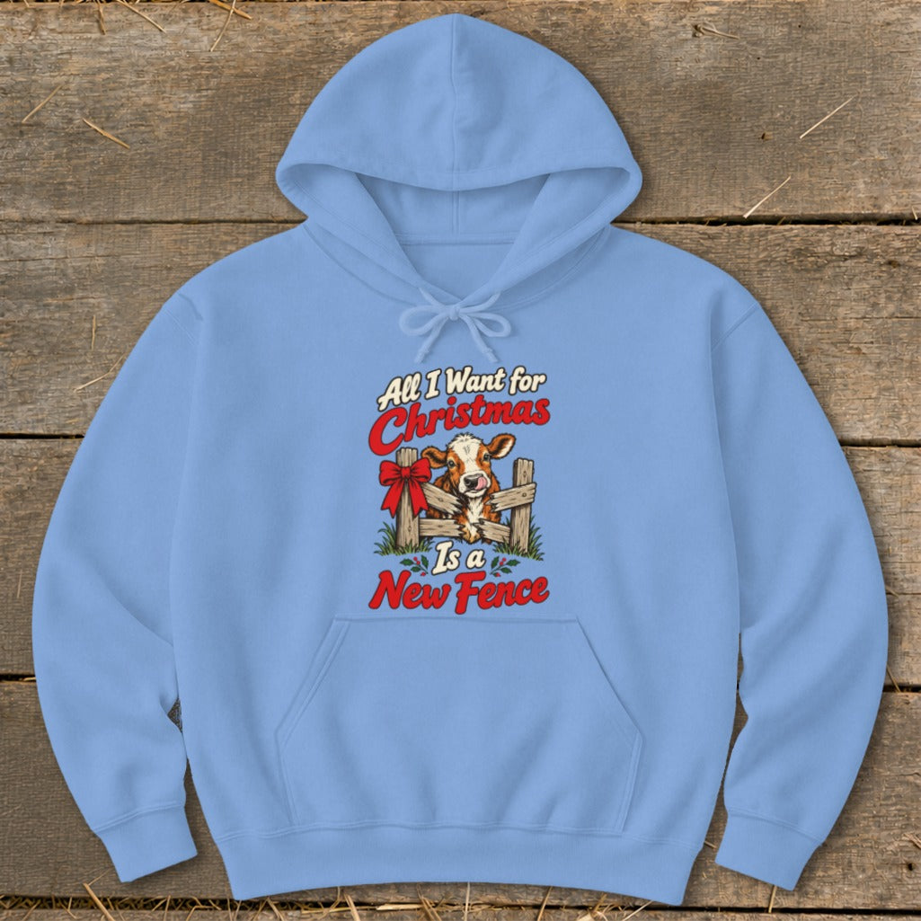 Light blue hoodie with Christmas cow graphic saying "All I Want for Christmas Is a New Fence."