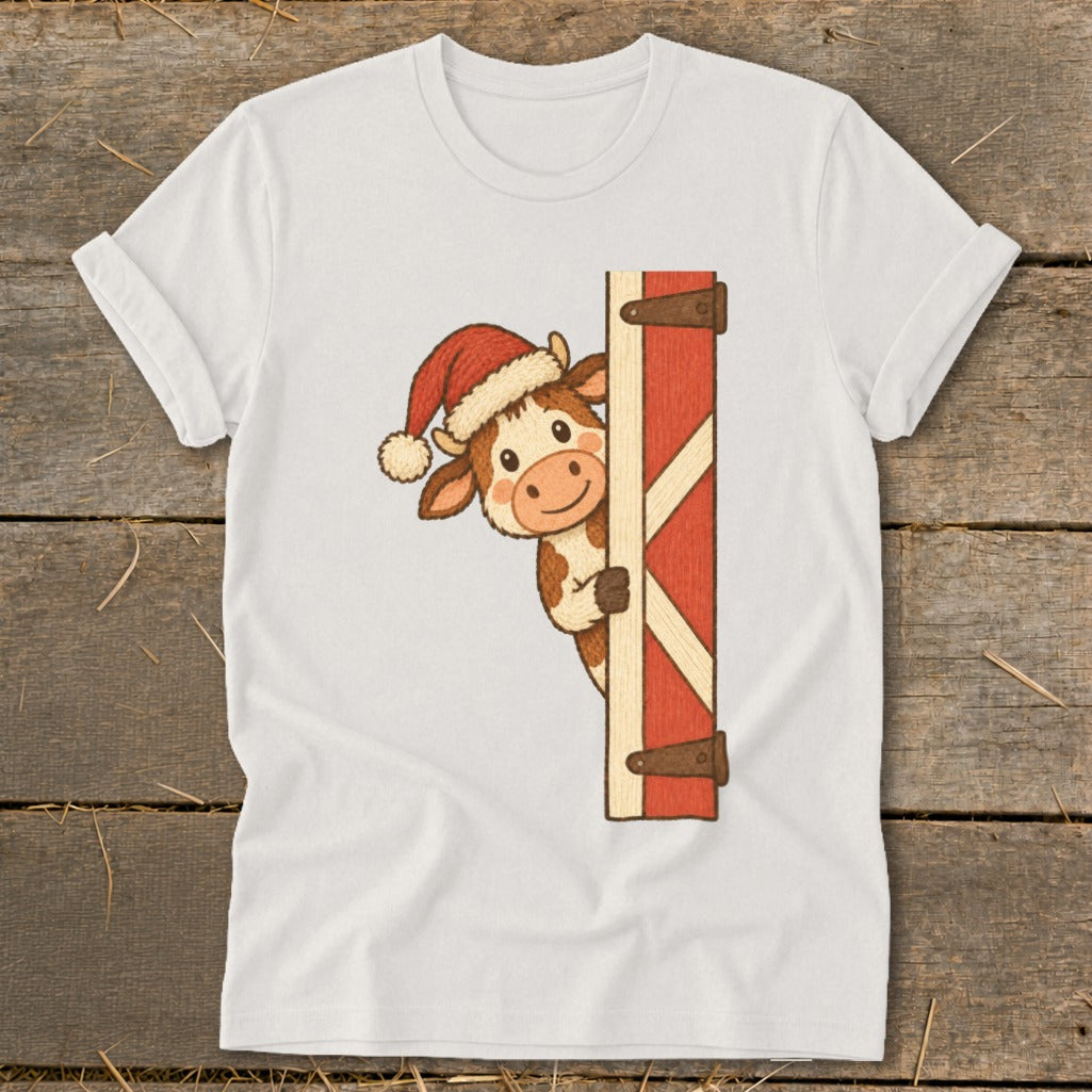 Cartoon cow wearing a Santa hat peeking from behind a barn door.