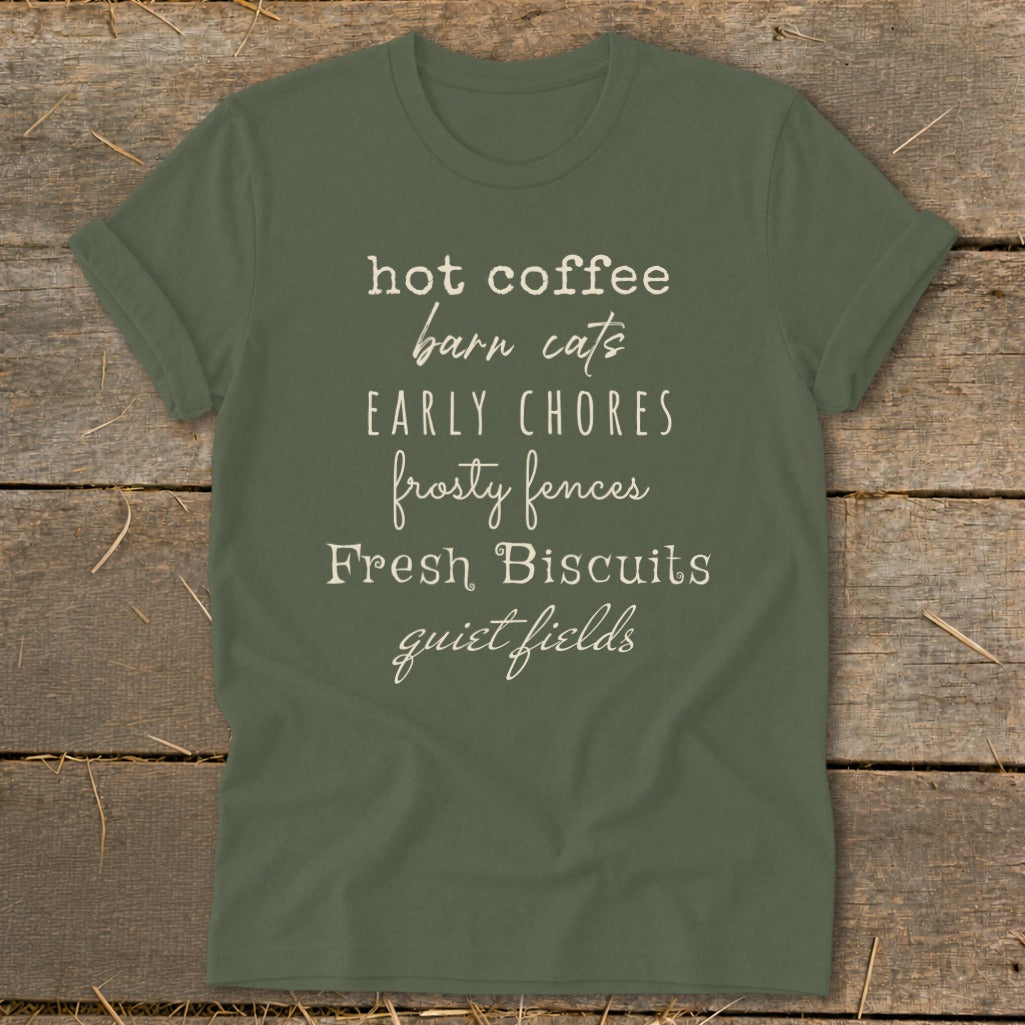 Olive green t-shirt with text: "hot coffee barn cats EARLY CHORES frosty fences Fresh Biscuits quiet fields".