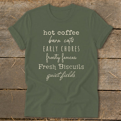Olive green t-shirt with text: "hot coffee barn cats EARLY CHORES frosty fences Fresh Biscuits quiet fields".