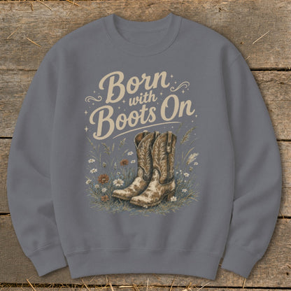 Sweatshirt with text "Born with Boots On" and cowboy boots in floral meadow.