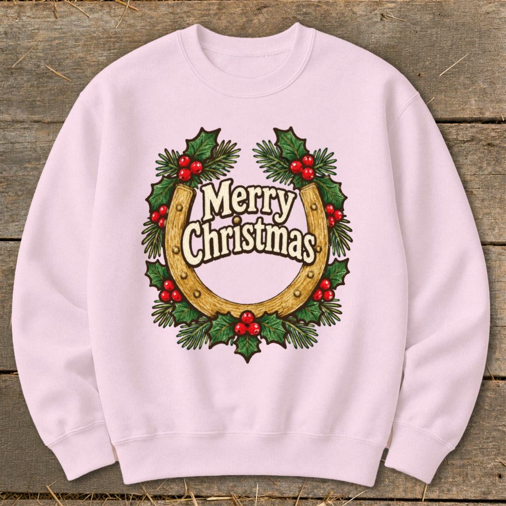 Pink sweatshirt with a horseshoe, holly, and "Merry Christmas" text graphic.