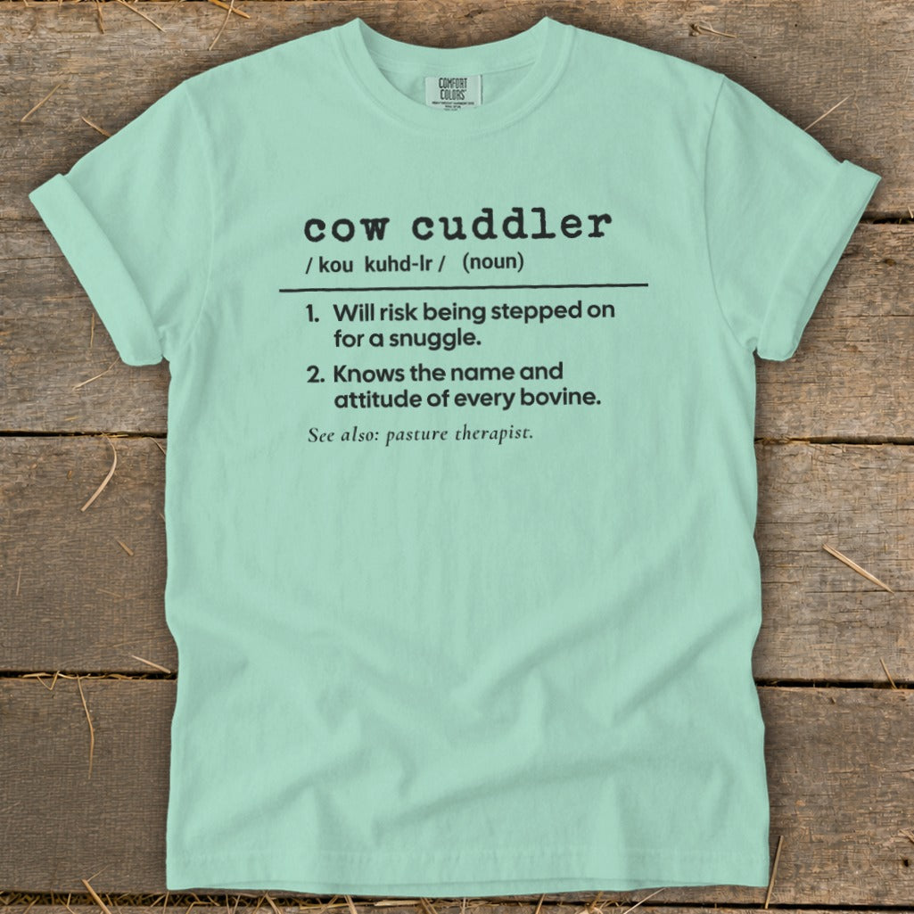 Light blue Comfort Colors t-shirt with "cow cuddler" definition.