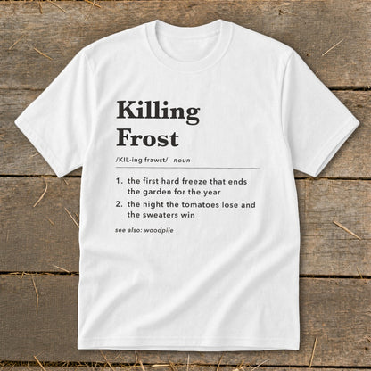 A white t-shirt printed with a dictionary definition of Killing Frost against a rustic wooden background.