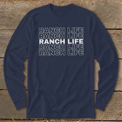Navy blue long-sleeved t-shirt with white block text reading Ranch Life repeated five times against a wooden background.
