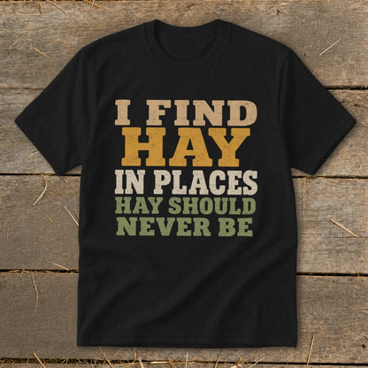 Black t-shirt with text "I FIND HAY IN PLACES HAY SHOULD NEVER BE".