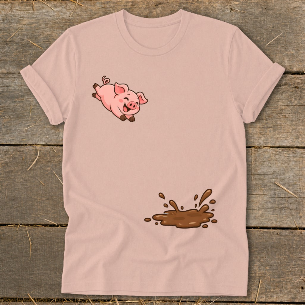 Pink t-shirt with a cartoon pig jumping into a mud puddle graphic.