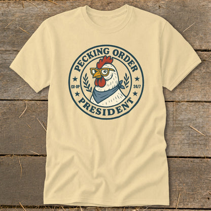 Cream t-shirt with a chicken wearing glasses and a bandana, text "Pecking Order President".