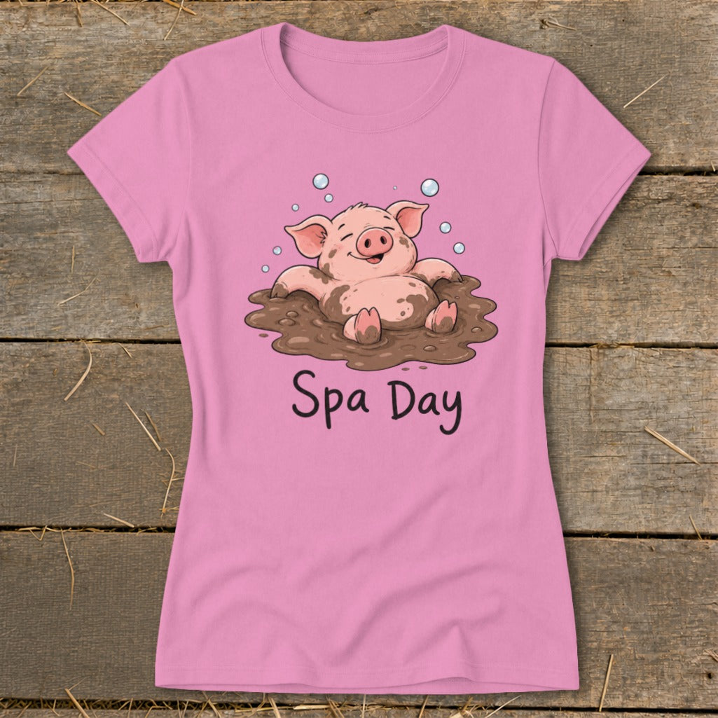 Pink t-shirt with a cartoon pig in mud with bubbles and "Spa Day" text.