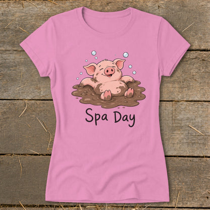 Pink t-shirt with a cartoon pig in mud with bubbles and "Spa Day" text.