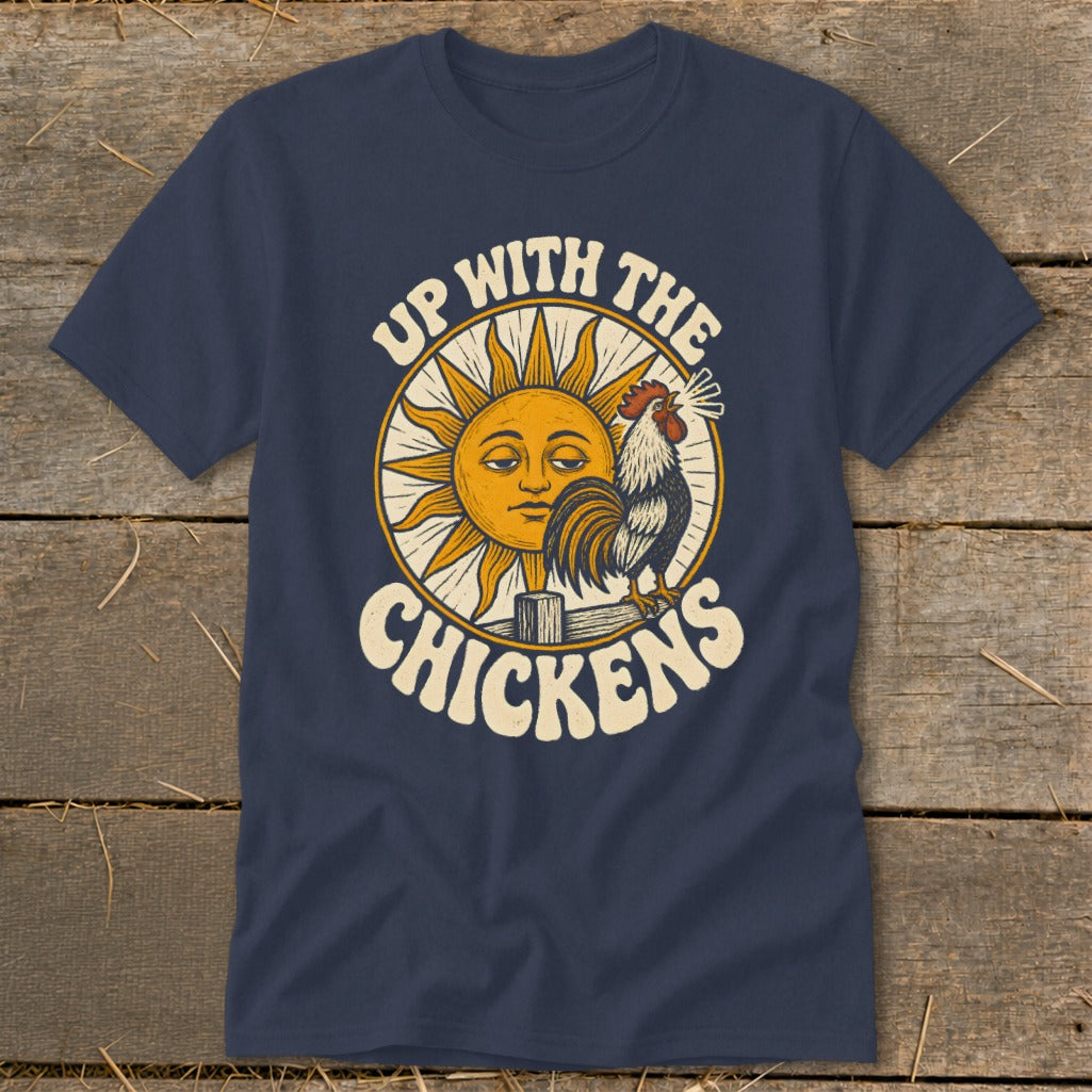 A dark blue t-shirt featuring a retro graphic of a crowing rooster, a sun, and the text Up with the Chickens.