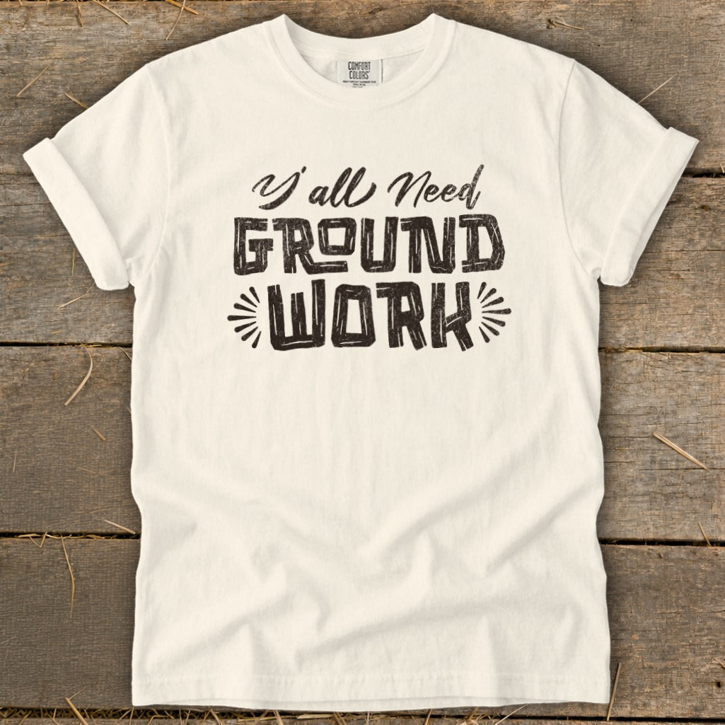 Cream t-shirt with "Y'all Need GROUND WORK" text in distressed black lettering.