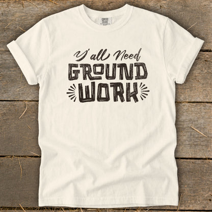 Cream t-shirt with "Y'all Need GROUND WORK" text in distressed black lettering.