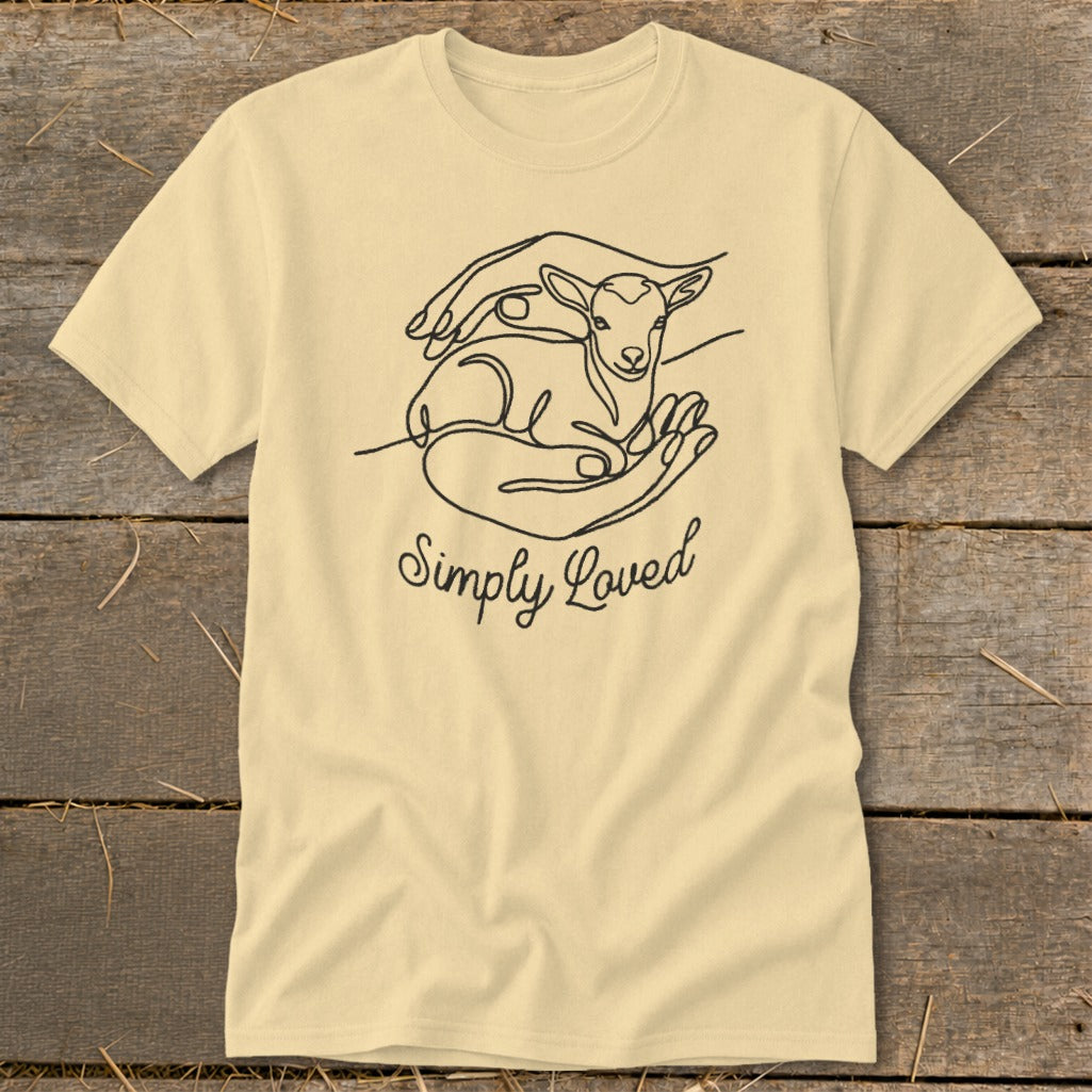 Light yellow t-shirt with black line art of hands holding a lamb and the text "Simply Loved".