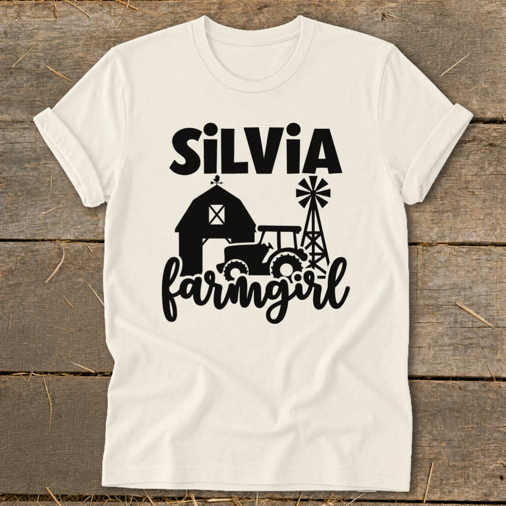 Cream t-shirt with "Silvia" and "farmgirl" text with barn, tractor, and windmill graphics.