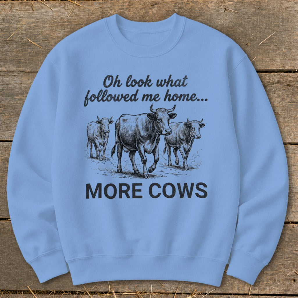 Light blue sweatshirt with three cows and the text "Oh look what followed me home... MORE COWS".