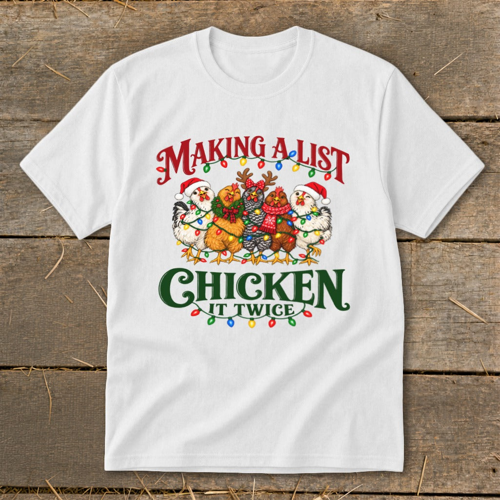 White t-shirt with five chickens wearing Santa hats and Christmas lights, text "MAKING A LIST CHICKEN IT TWICE."