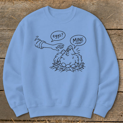 Light blue sweatshirt with a drawing of a chicken protecting its eggs from a hand.