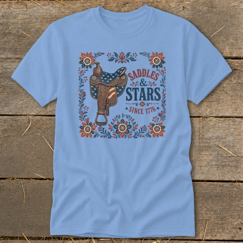 Light blue t-shirt with vintage-style western saddle and "Saddles & Stars Since 1776" text.