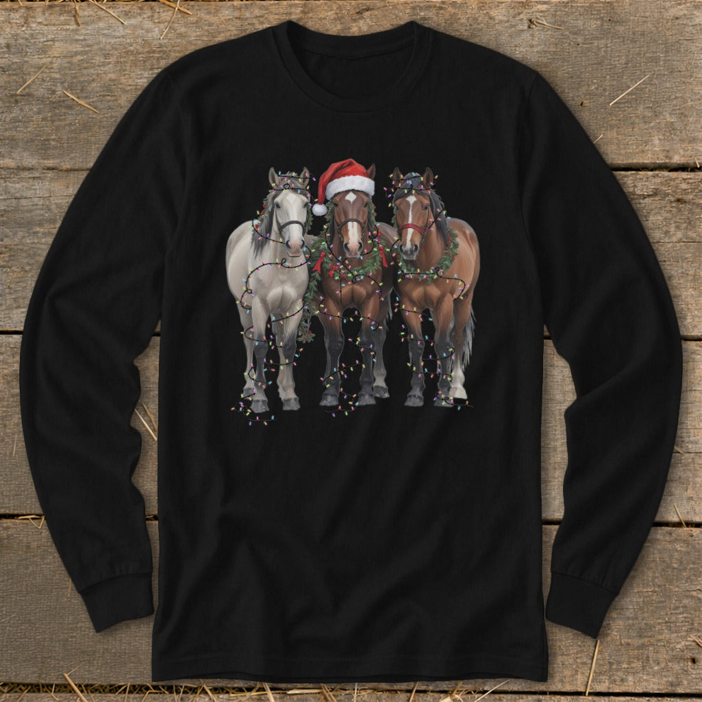 Three horses adorned with Christmas lights and garland, one wearing a Santa hat.