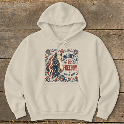Cream hoodie with vintage patriotic horse graphic and text "HOOFBEATS & FREEDOM SINCE 1776".