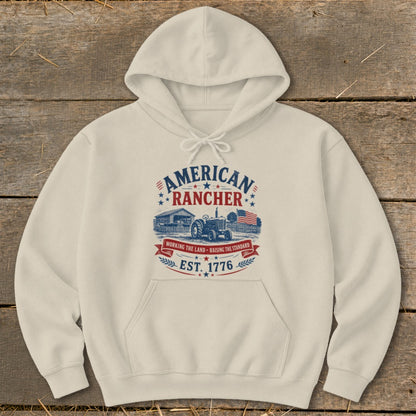Cream hoodie with "American Rancher Est. 1776" graphic featuring a barn and tractor.
