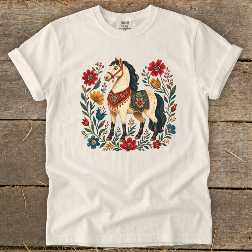 Cream t-shirt with a cream horse illustration surrounded by colorful flowers and foliage.