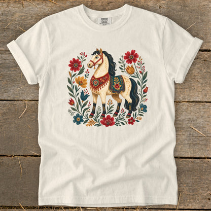 Cream t-shirt with a cream horse illustration surrounded by colorful flowers and foliage.