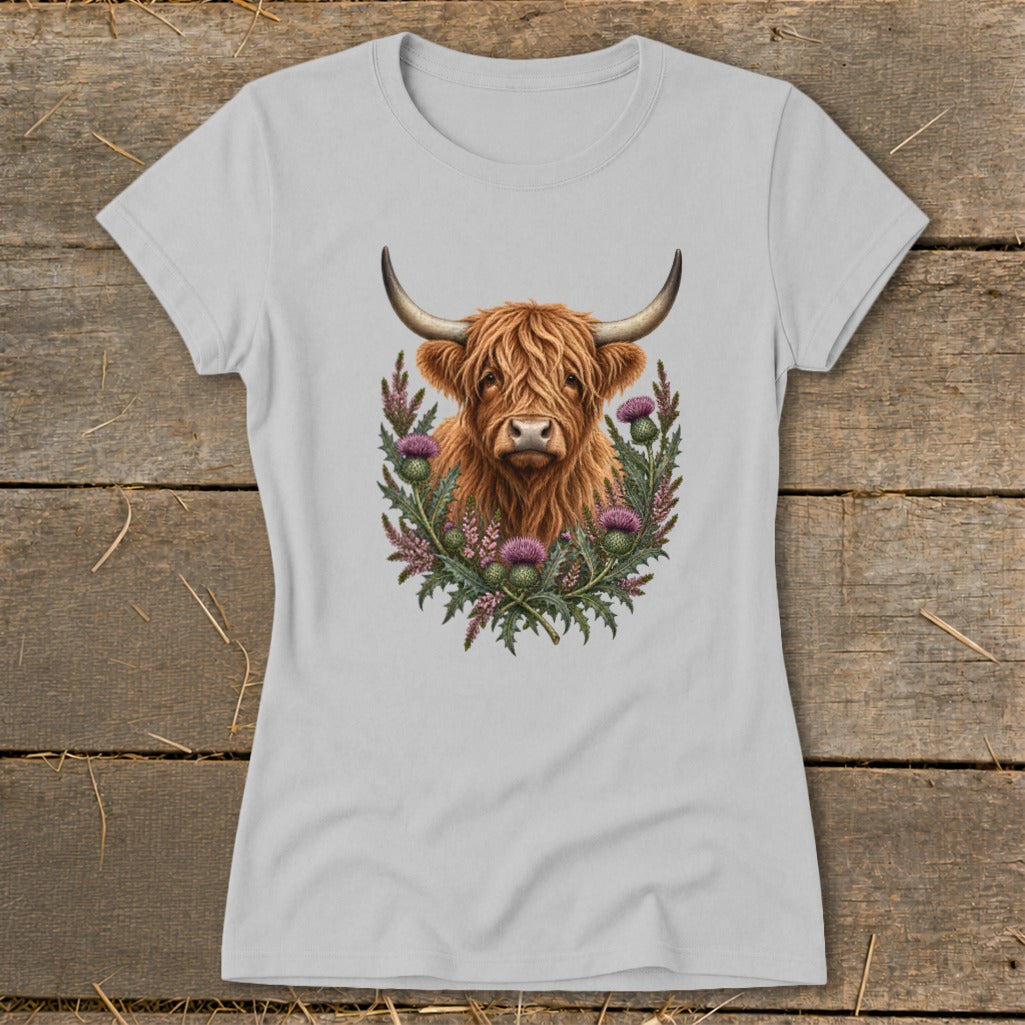 Highland cow portrait surrounded by thistles on a light gray t-shirt.