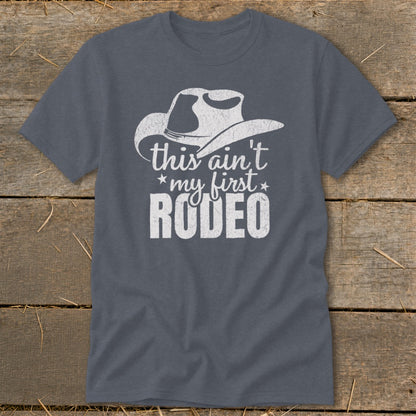 Gray t-shirt with white cowboy hat graphic and "this ain't my first RODEO" text.
