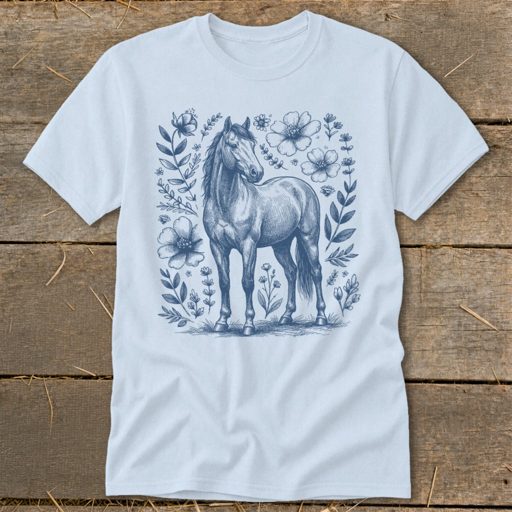 Light blue t-shirt with a blue sketch of a horse surrounded by floral elements.