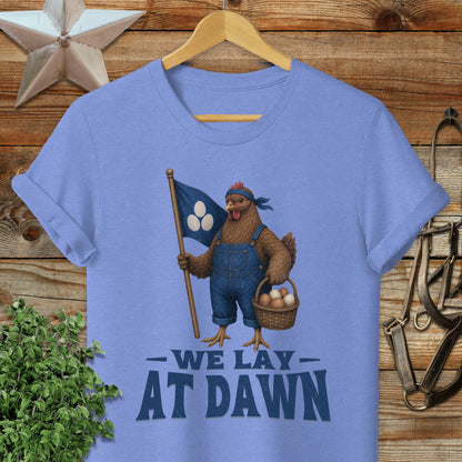 T-shirt with chicken in overalls holding a flag and basket, text "We Lay At Dawn".