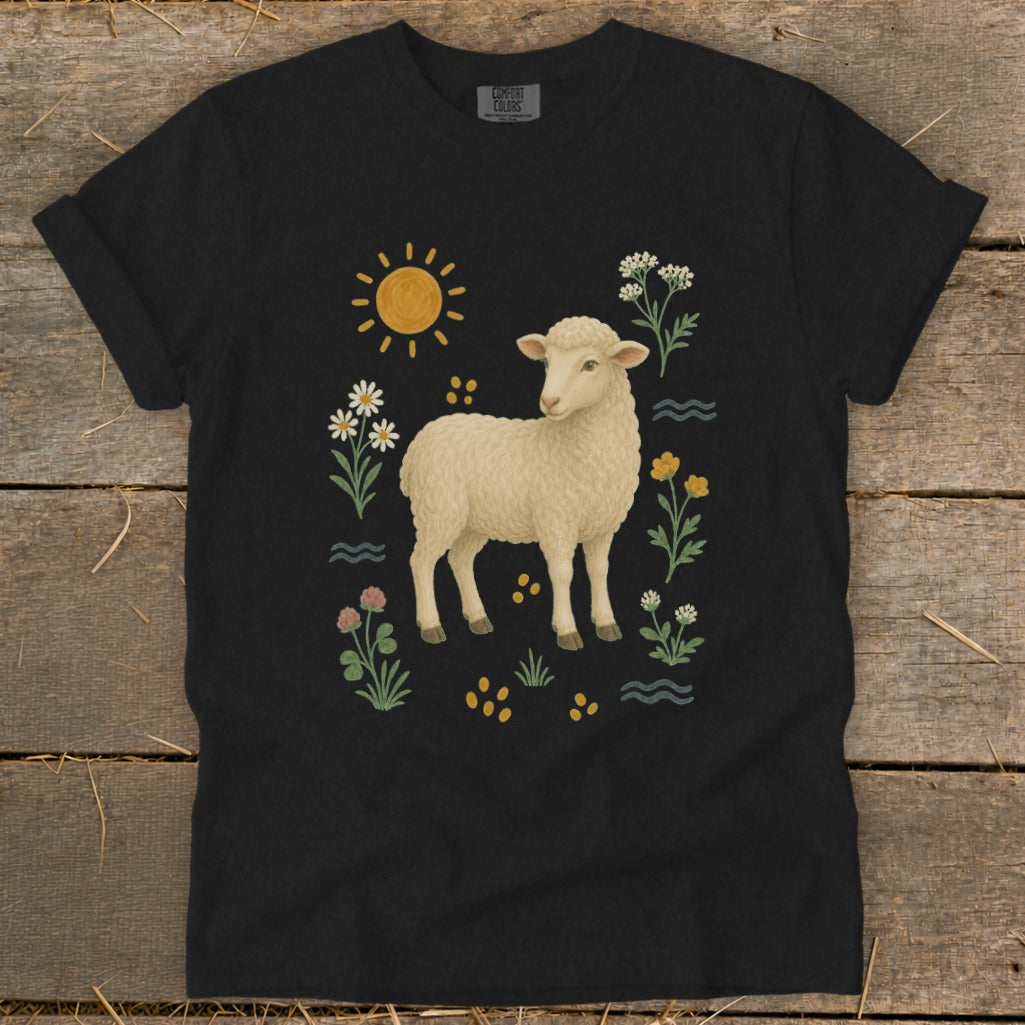 Black t-shirt with a graphic of a lamb, sun, and wildflowers.
