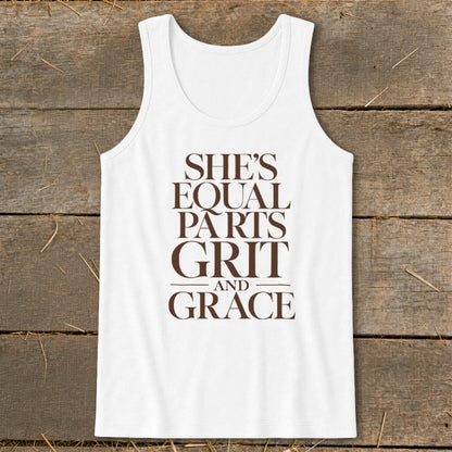 White tank top with brown text: "SHE'S EQUAL PARTS GRIT AND GRACE".